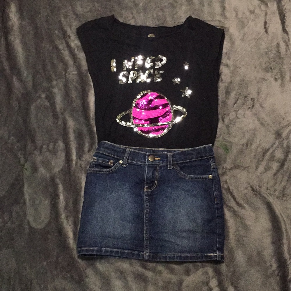 A denim Jean skirt with and black space shirt